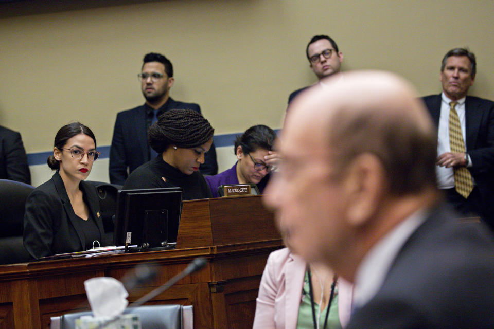 Representative Alexandria Ocasio-Cortez, a Democrat from New York, left, listens during a House Oversight Committee hearing with Wilbur Ross, U.S. commerce secretary, right, in Washington, D.C., U.S., on Thursday, March 14, 2019. A main topic of the hearing is to be allegations by committee Democrats that Ross has given misleading testimony on multiple occasions to Congress about the citizenship question to the 2020 Census. Photographer: Andrew Harrer/Bloomberg via Getty Images