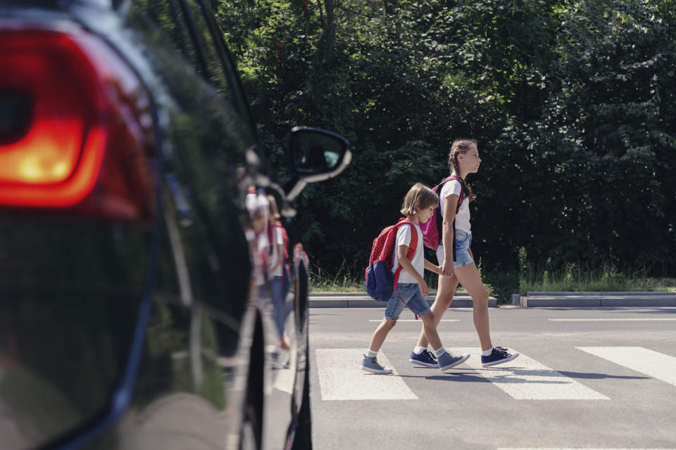 Children crossing road near car. Source: Getty Images