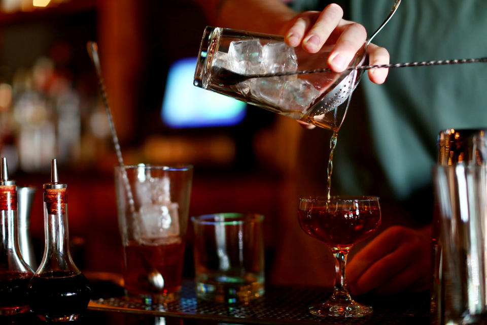 bartender's hand pouring a cocktail