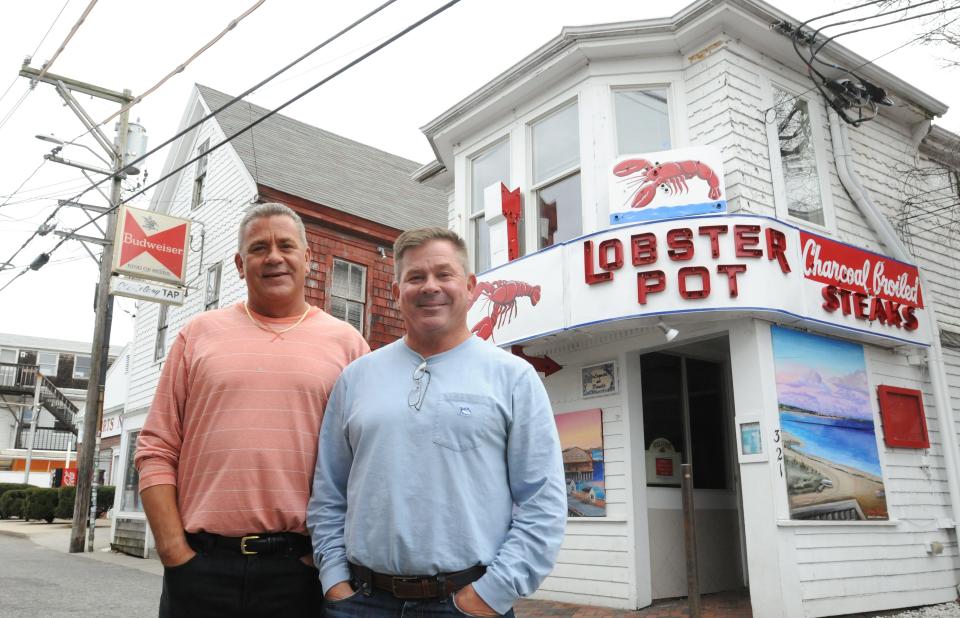 Brothers Tim McNulty, right, and Shawn McNulty stand outside their iconic Commercial Street restaurant, Lobster Pot, in Provincetown. The family has put the business and property up for sale at $14 million.