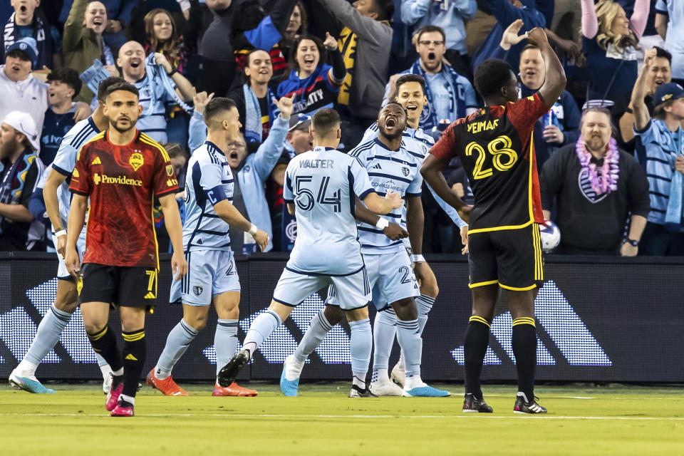 Sporting Kansas City forward Willy Agada (23) celebrates with teammates after scoring a goal during the first half of an MLS soccer match against the Seattle Sounders, Saturday, March 25, 2023, in Kansas City, Kan. (AP Photo/Nick Tre. Smith)