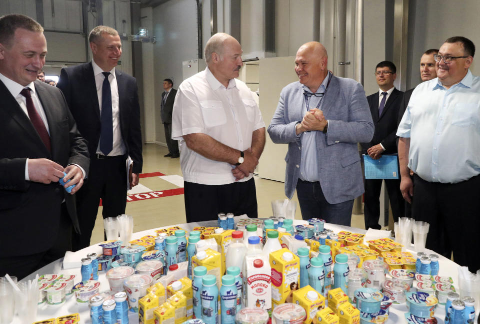 Belarus President Alexander Lukashenko, center, speaks with officials as he visits the baby food plant in the town of Nesvizh, Belarus, Monday, July 27, 2020. The presidential election in Belarus is scheduled for Aug. 9, 2020. (Nikolai Petrov/BelTA Pool Photo via AP)
