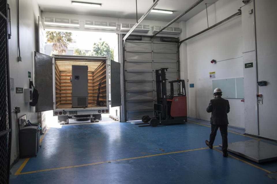 A freezer sits in the back of a truck to be stored at a Health Ministry warehouse where COVID-19 vaccines will be kept cold, during a media tour in Bogota, Colombia, Tuesday, Jan. 19, 2021. (AP Photo/Ivan Valencia)