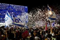 Supporters of the new Israeli government celebrate in Tel Aviv