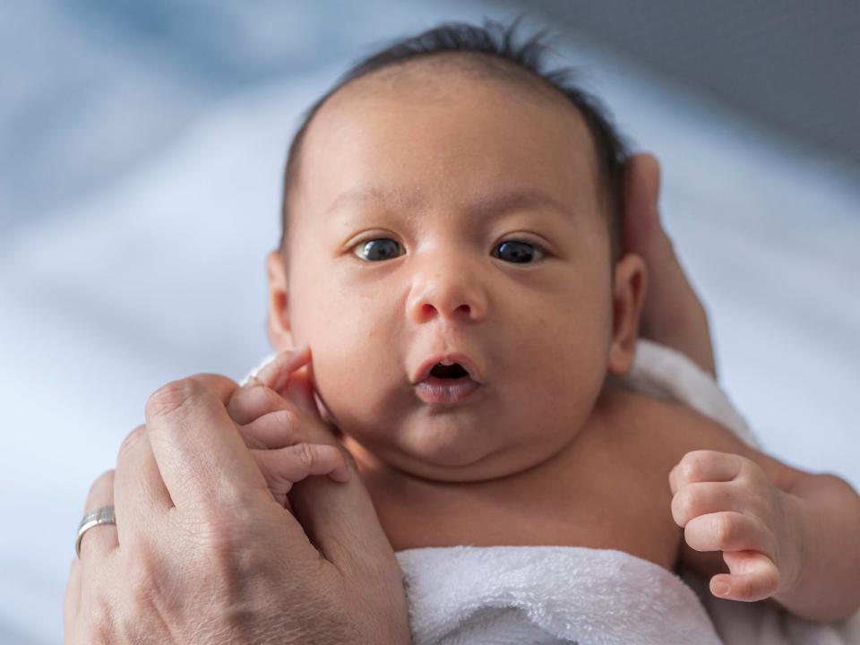 A stock image shows a small baby boy