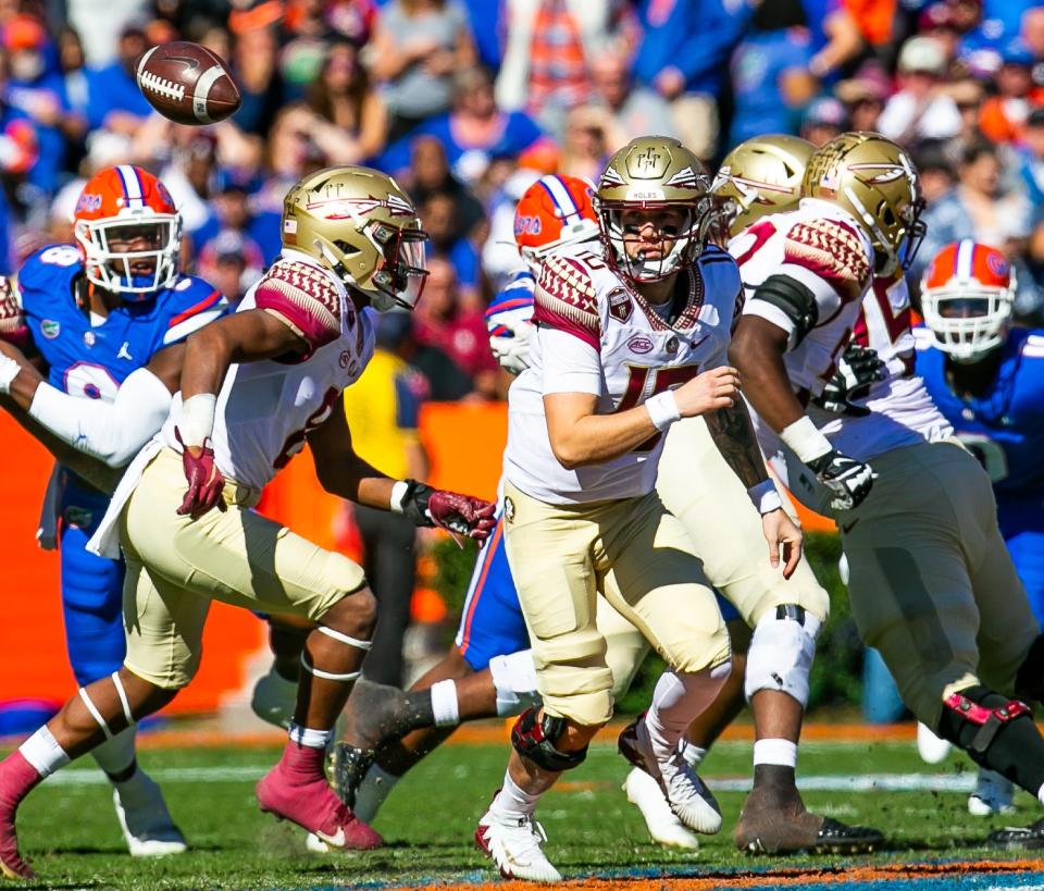 Florida State Seminoles quarterback McKenzie Milton (10) goes after a snap over his head in the first half. The Florida Gators hosted the Florida State Seminoles Saturday November 27, 2021 at Ben Hill Griffin Stadium in Gainesville, Florida.