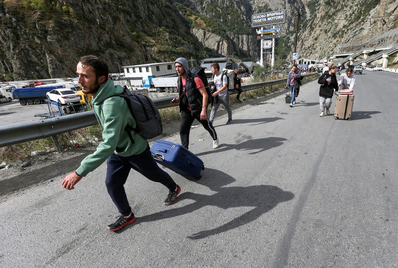 FILE PHOTO: People cross border at Zemo Larsi checkpoint while leaving Russia