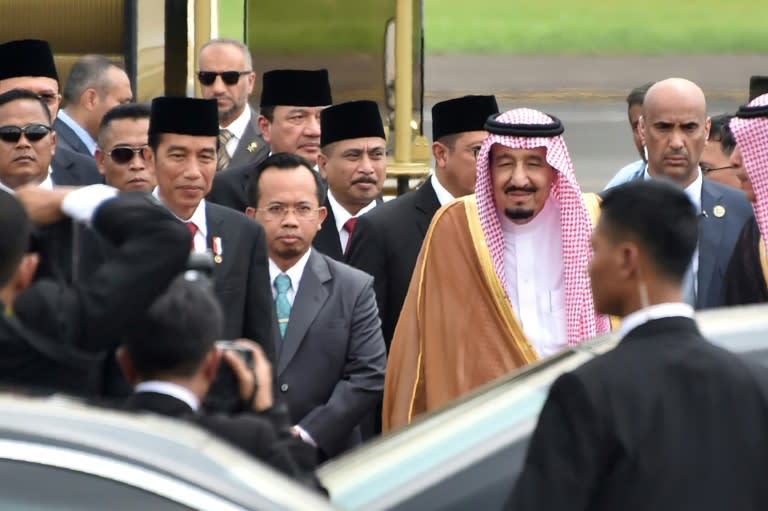 Indonesia's President Joko Widodo (centre L) welcomes Saudi Arabia's King Salman bin Abdul Aziz (centre R) at Halim airport in Jakarta on March 1, 2017