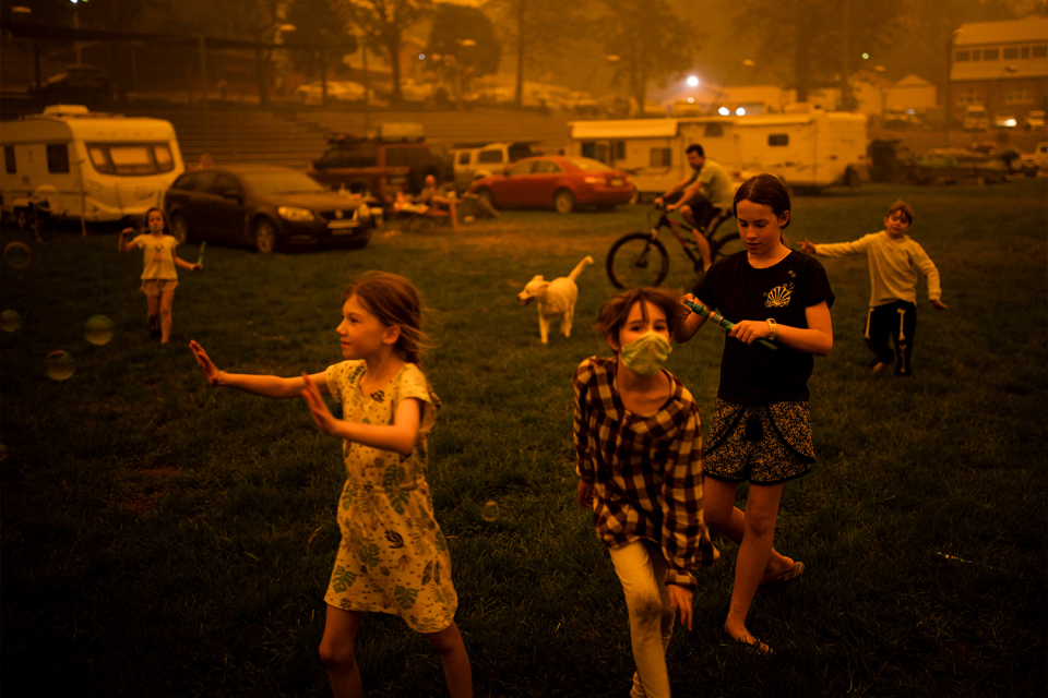  Children play at the showgrounds in the southern New South Wales town of Bega where they are camping after being evacuated from nearby sites affected by bushfires on December 31, 2019. Thousands of holidaymakers and locals were forced to flee to beaches in fire-ravaged southeast Australia on December 31, as blazes ripped through popular tourist areas leaving no escape by land. 