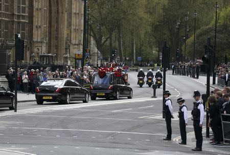 Police officers line the street as the coffin of PC Keith Palmer, who was killed in the recent Westminster attack, is transported from the Palace of Westminster, where it laid overnight, to his funeral at Southwark Cathedral in central London, Britain April 10, 2017. REUTERS/Neil Hall