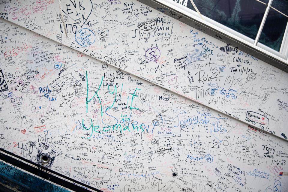 Signatures dot the boat that was pushed onto the dock at Bonita Bills Restaurant by Hurricane Ian on Fort Myers Beach. Patrons of the restaurant are able to sign the side of the boat. It is unknown when the boat will be removed.