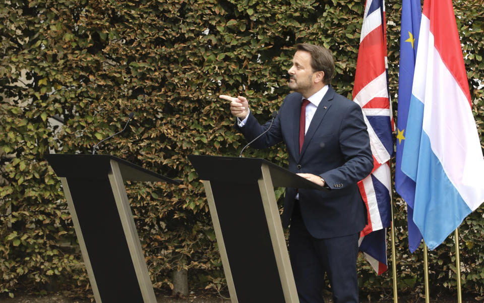 Luxembourg's Prime Minister Xavier Bettel, right, addresses a media conference next to an empty lectern intended for British Prime Minister Boris Johnson after a meeting at the prime ministers office in Luxembourg, Monday, Sept. 16, 2019. (AP Photo/Olivier Matthys)