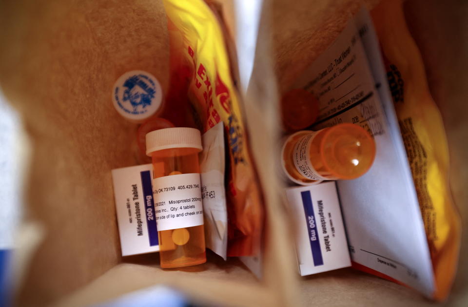 Paper bags containing the medication used for a medical abortion, follow-up instructions, and heating pads are prepared for patients who will be having abortions that day at a clinic in Oklahoma City, Okla.