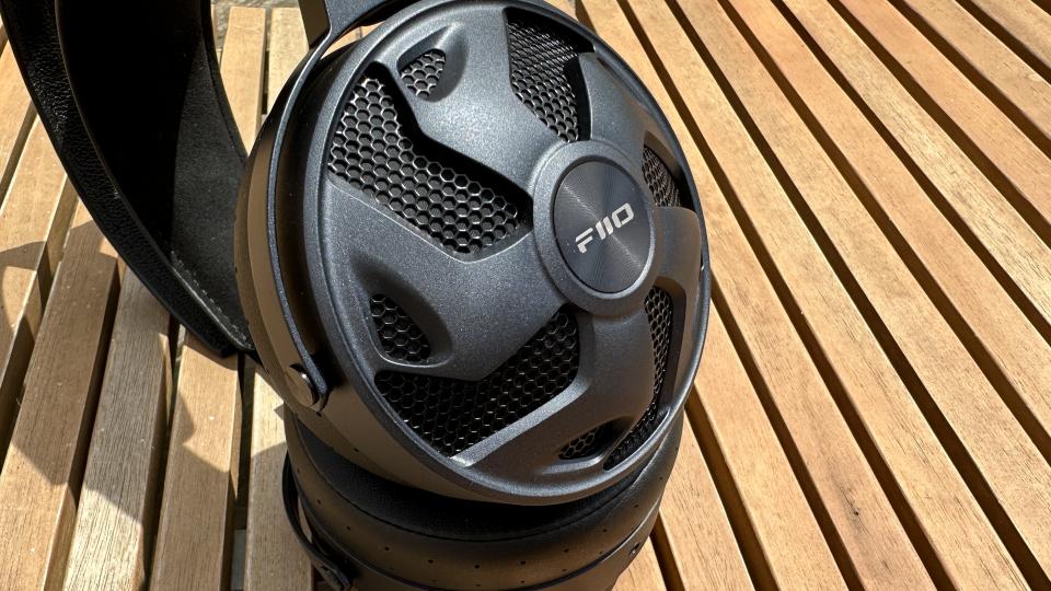 A close-up of the FiiO FT3 headhpones on a wooden surface