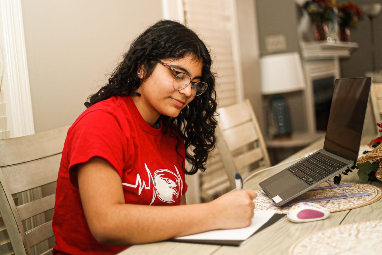 Krissia Rivera works on her school work at the table at her parents’ home on Friday, March 1, 2024 in Memphis, Tenn.