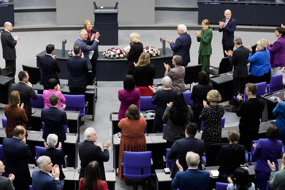 Britain's King Charles III, center left, waves as he receives a standing ovation after his speech in the German Bundestag in Berlin, Thursday, March 30, 2023. King Charles III arrived Wednesday for a three-day official visit to Germany. (AP Photo/Markus Schreiber)