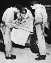 Men who helped drop the second war-stopping atomic bomb on Nagasaki, Japan, study a map of their objective shortly before the take off of the B-29 “77” which dropped the bomb on Aug. 9, 1945. Left to right: Capt. Theo J. Van Kirk, navigator, who also made flight aboard the ‘Enola Gay’ when it dropped the first atom bomb on Hiroshima; Major Sweeney, commanding officer of the 393 bomb squadron and pilot. (Photo: Bettmann/Getty Images)