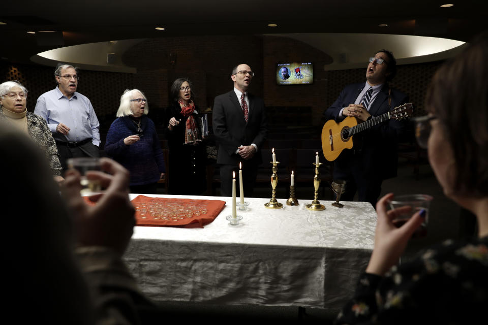 In this Jan. 17, 2020, photo Cantor David Berger, right, sings a song with members of KAM Isaiah Israel during the Friday Shabbat Service at KAM Isaiah Israel in Chicago. On the eve of the day set aside to honor an African American who strove against hate and preached racial and social justice, some worry the nation is becoming more divided. (AP Photo/Nam Y. Huh)