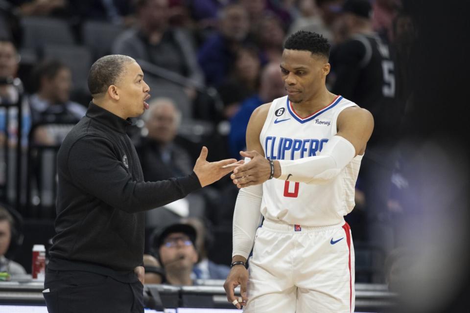 Clippers coach Tyronn Lue greets point guard Russell Westbrook as he heads to the sideline.