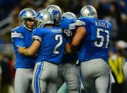 Detroit Lions kicker David Akers (2) celebrates with teammate after kicking the game winning extra point during the fourth quarter to defeat the Dallas Cowboys 31-30 at Ford Field. Mandatory Credit: Andrew Weber-USA TODAY Sports