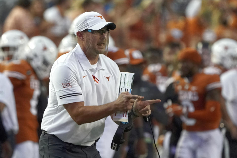 FILE - Texas head coach Tom Herman shouts to his team during the first half of an NCAA college football game against UTEP in Austin, Texas,in this Saturday, Sept. 12, 2020, file photo. When Texas finished its season with consecutive lopsided victories, it seemed that coach Tom Herman would be back for a fifth season despite again falling short of a Big 12 title. There was no reason to think Les Miles would be gone from Kansas, even after a winless second season. Yet, the Longhorns and Jayhawks both went through spring practice with different coaches. (AP Photo/Chuck Burton, File)