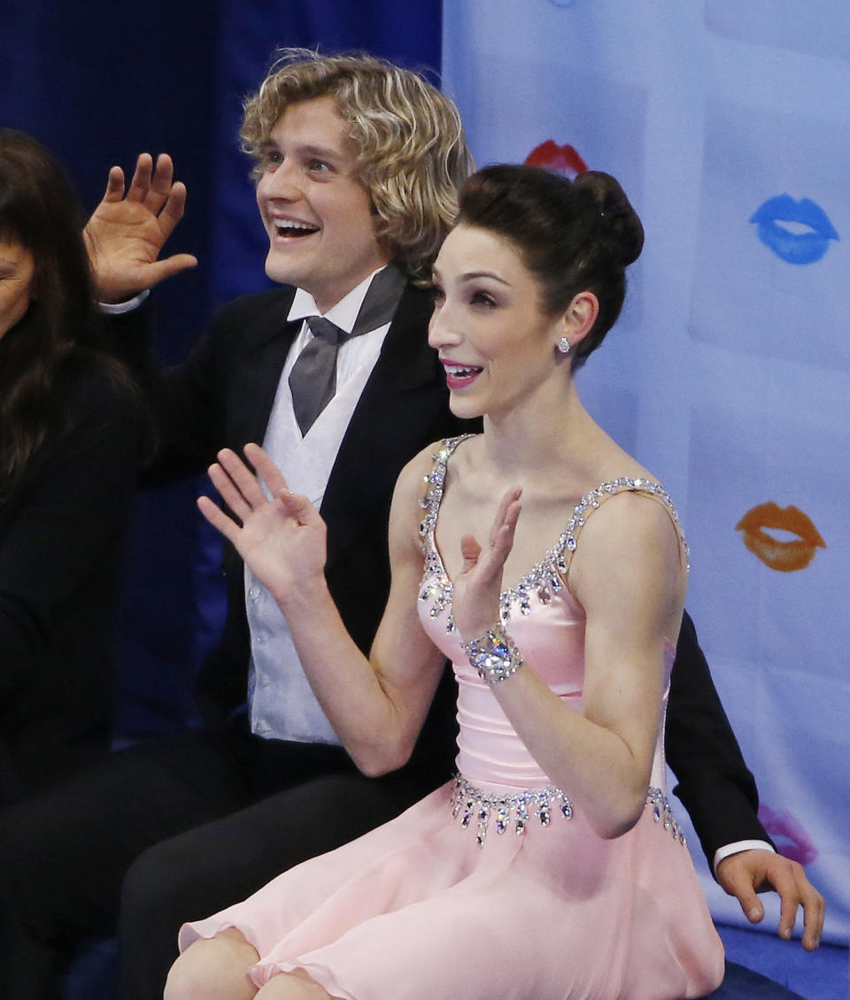 Meryl Davis and Charlie White react as scores are posted after skating during the ice dance short program at the U.S. Figure Skating Championships in Boston, Friday, Jan. 10, 2014. (AP Photo/Elise Amendola)