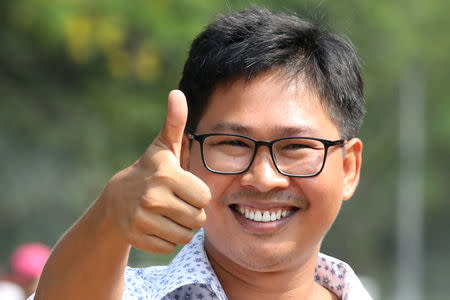 Reuters reporter Wa Lone gives a thumbs up as he walks to Insein prison gate after being freed, after receiving a presidential pardon in Yangon, Myanmar, May 7, 2019. REUTERS/Ann Wang