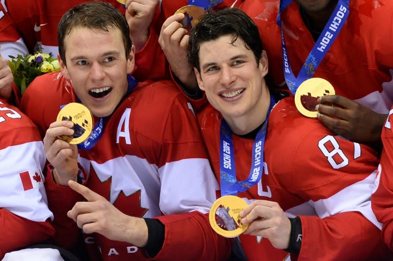Canada's gold medallists Jonathan Toews (left) and Sidney Crosby pose during the Men's Ice Hockey Medal Ceremony during the Sochi Winter Olympics on February 23, 2014