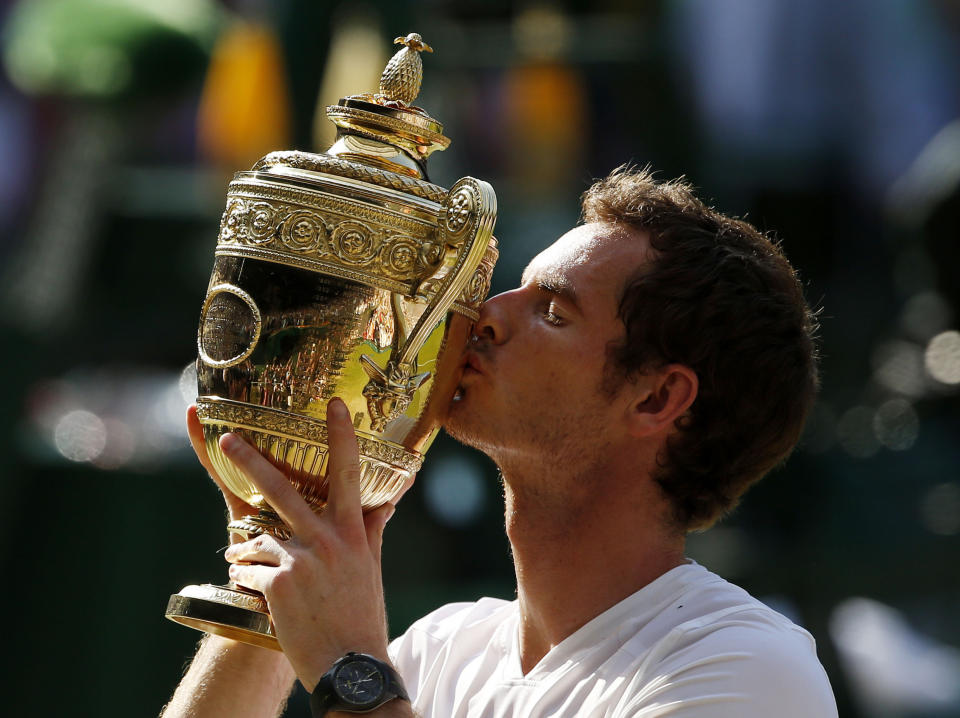 Great Britain's Andy Murray celebrates with the trophy after defeating Serbia's Novak Djokovic in the Men's Final during day thirteen of the Wimbledon Championships at The All England Lawn Tennis and Croquet Club, Wimbledon.