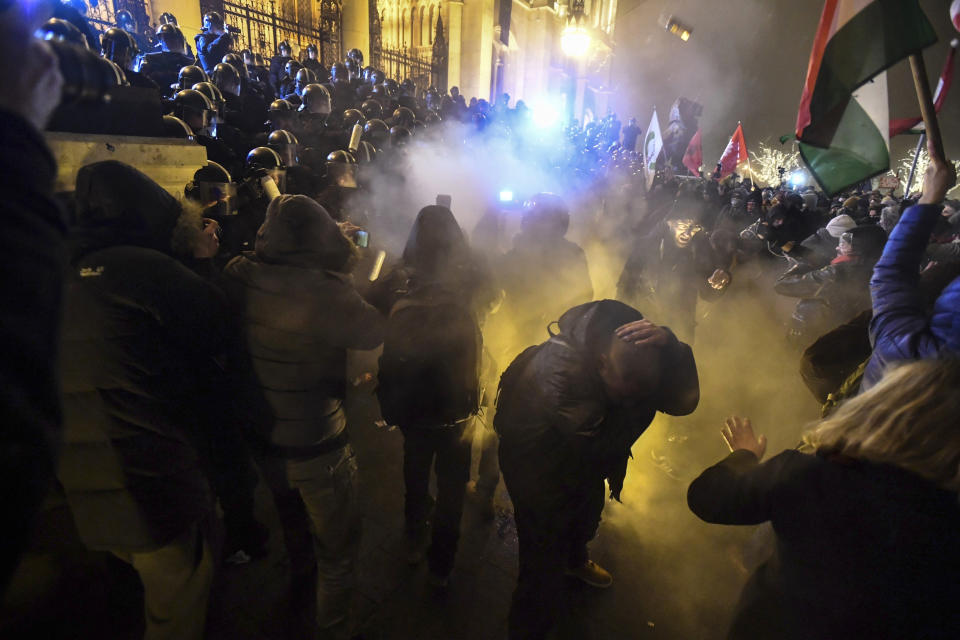 Protesters clash with police during a demonstration against the amendments to the labour code, dubbed "slave law" by oppositional forces, at the parliament building in Budapest, Hungary, Dec. 13, 2018. The rally, which was announced by the Free University and Students Trade Union student groups, started peacefully but police later responded to aggressive protestors with teargas. (Marton Monus/MTI via AP)