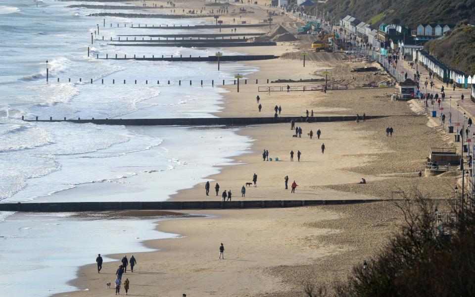 Members of the public walk on the beach on the weekend in Bournemouth, Dorset - Finnbarr Webster/Getty