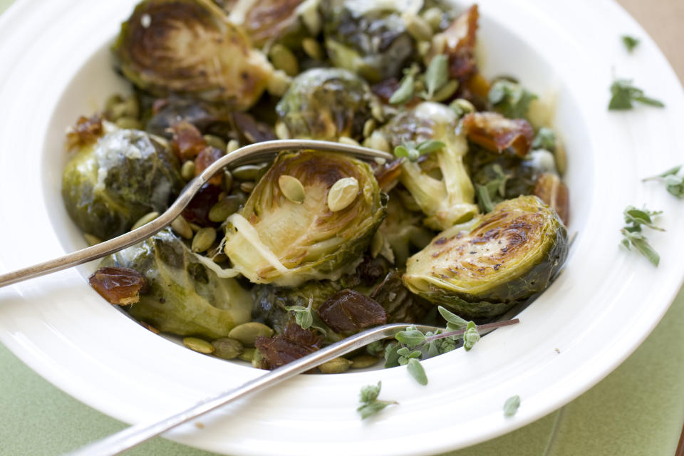 This Oct. 14, 2013 photo shows Gruyere roasted brussels sprouts with pepitas and dates in Concord, N.H. (AP Photo/Matthew Mead)