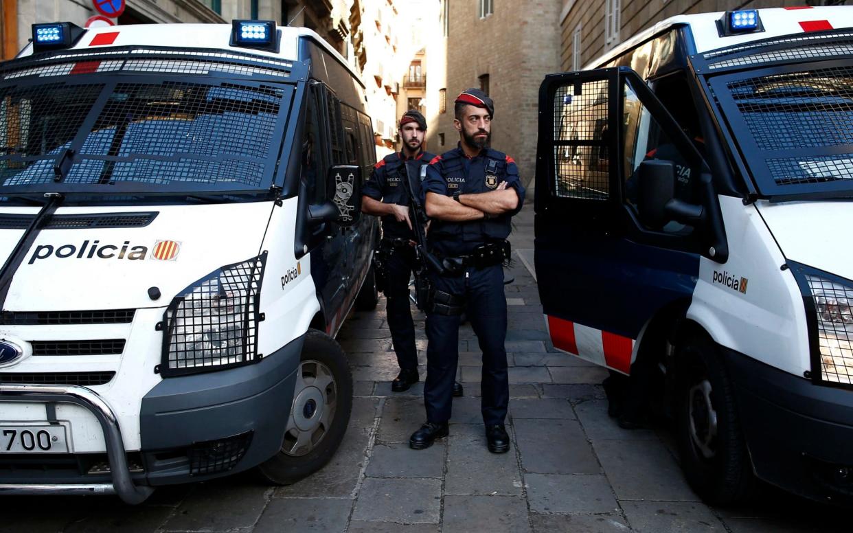 Catalan police officers stand guard next to the Palau Generalitat in Barcelona - AP