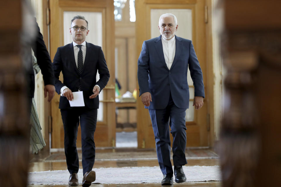 Iranian Foreign Minister Mohammad Javad Zarif, right, and his German counterpart Heiko Maas walk to a press conference after their talks, in Tehran, Iran, Monday, June 10, 2019. Iran's foreign minister warned the U.S. on Monday that it "cannot expect to stay safe" after launching what he described as an economic war against Tehran, taking a hard-line stance amid a visit by Germany's top diplomat seeking to defuse tensions. (AP Photo/Ebrahim Noroozi)