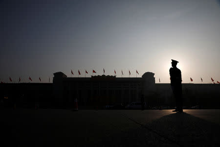 A paramilitary police officer stands guard outside the Great Hall of the People ahead of National People's Congress (NPC), China's annual session of parliament, in Beijing, China March 4, 2019. REUTERS/Aly Song