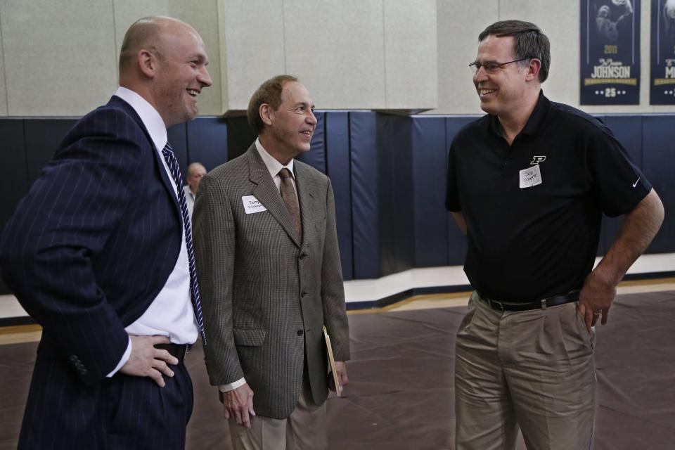 Former Purdue basketball greats Brian Cardinal,from left, Terry Dischinger and Steve Scheffler share a laugh prior to the Boilermakers game with Nebraska Sunday, February 15, 2015, on Cardinal Court in Mackey Arena.