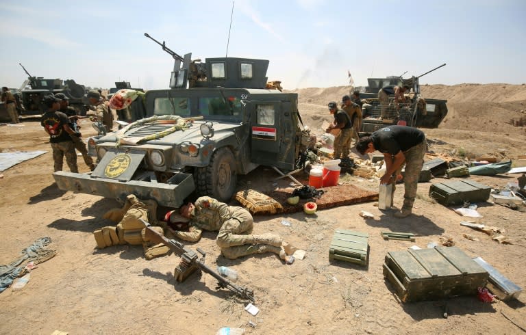 Pro-government forces rest after battling Islamic State group jihadists near al-Sejar village, north-east of Fallujah