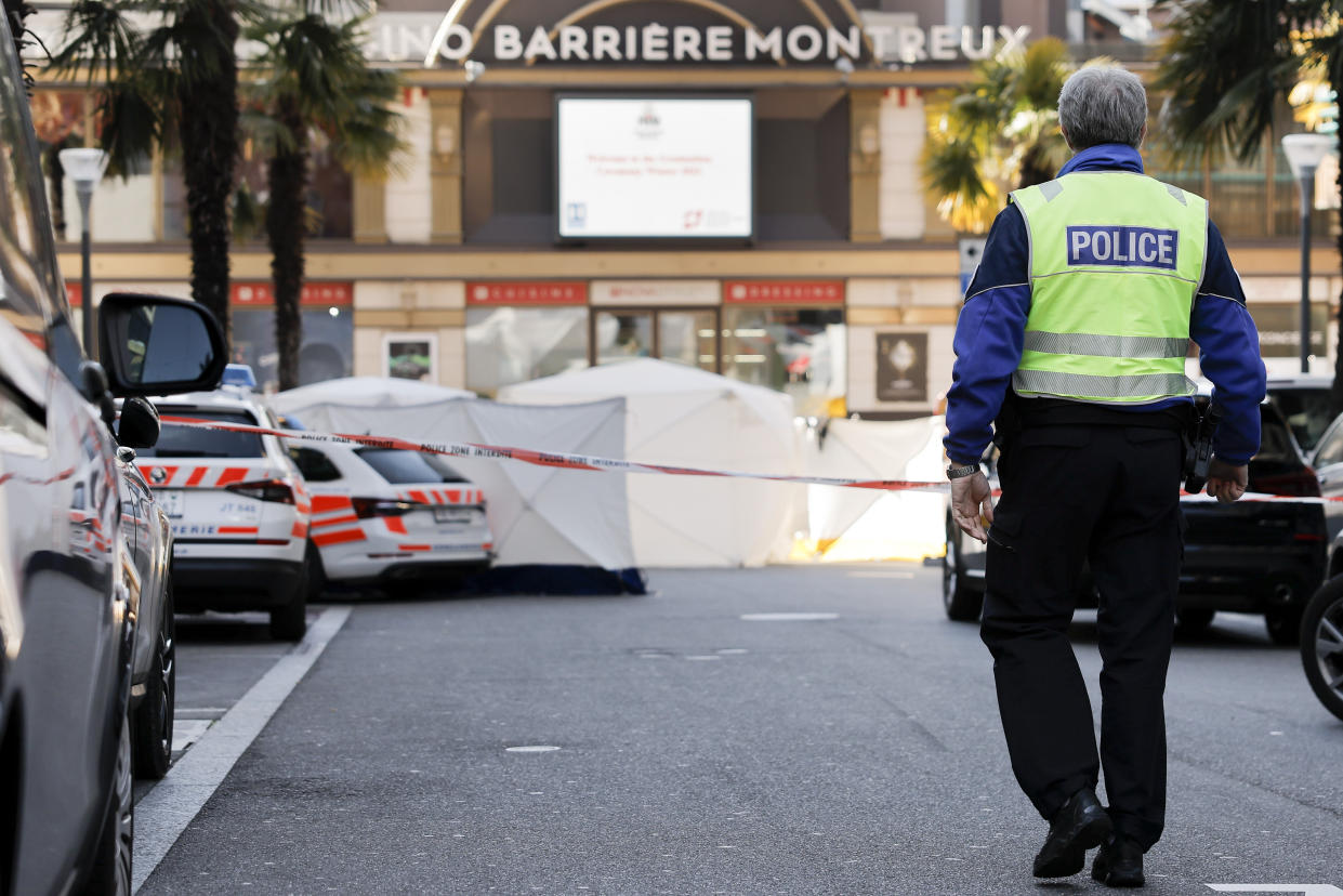 Cars and tents block a road in Montreux, Switzerland, Thursday, March 24, 2022. Swiss police say four people have been found dead at the foot of a building in Montreux, with a fifth person hospitalized in serious condition. A spokesman for the regional Vaud police told The Associated Press that he could not immediately confirm a news report in Swiss daily Blick, citing an unidentified police official, saying that the five had jumped from a building. (Cyril Zingaro/Keystone via AP)