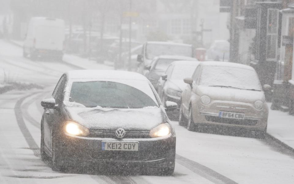 A car driving through a snow flurry in Lenham, Kent. Sleet and snow showers have been forecast for parts of the country on Monday