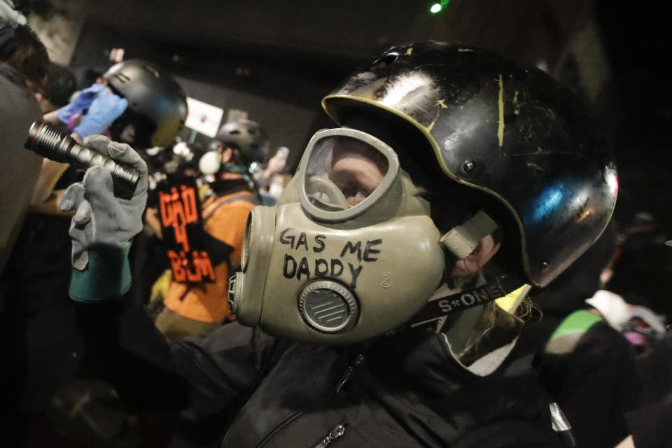 A demonstrator wears a face mask during a Black Lives Matter protest at the Mark O. Hatfield United States Courthouse Saturday, July 25, 2020, in Portland, Ore. (AP Photo/Marcio Jose Sanchez)