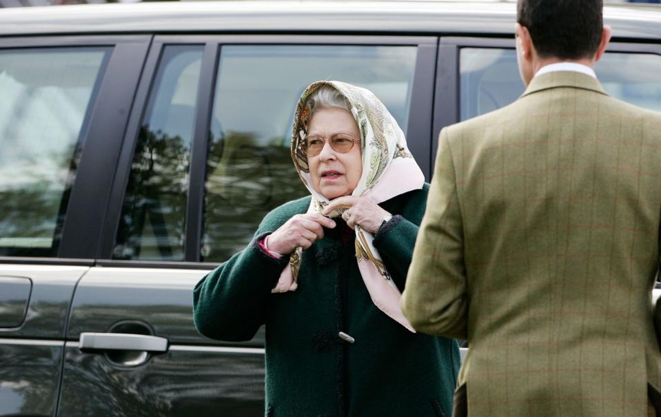 <p>The Queen is rarely seen in public or on a casual outing without a headscarf — they are <a href="https://www.standard.co.uk/fashion/queen-elizabeth-ii-headscarves-fashion-a4380806.html" rel="nofollow noopener" target="_blank" data-ylk="slk:an essential item in her wardrobe;elm:context_link;itc:0;sec:content-canvas" class="link ">an essential item in her wardrobe</a>. And she needs no help fastening them, as demonstrated here at the Royal Windsor Horse Show in 2005.</p>