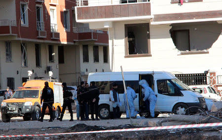 Forensics and police officers work on the blast scene after Friday's explosion outside a housing complex in the southeastern Turkish town of Viransehir in Sanliurfa province, Turkey, near the border with Syria, February 18, 2017. REUTERS/Kadir Celikcan