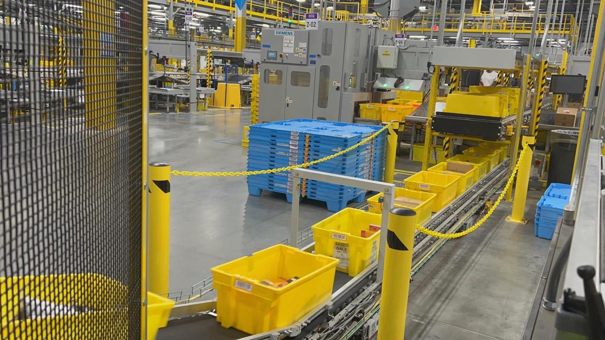 A stream of yellow totes are seen on one of the conveyer belt at Amazon's new fulfillment center in Tallahassee.