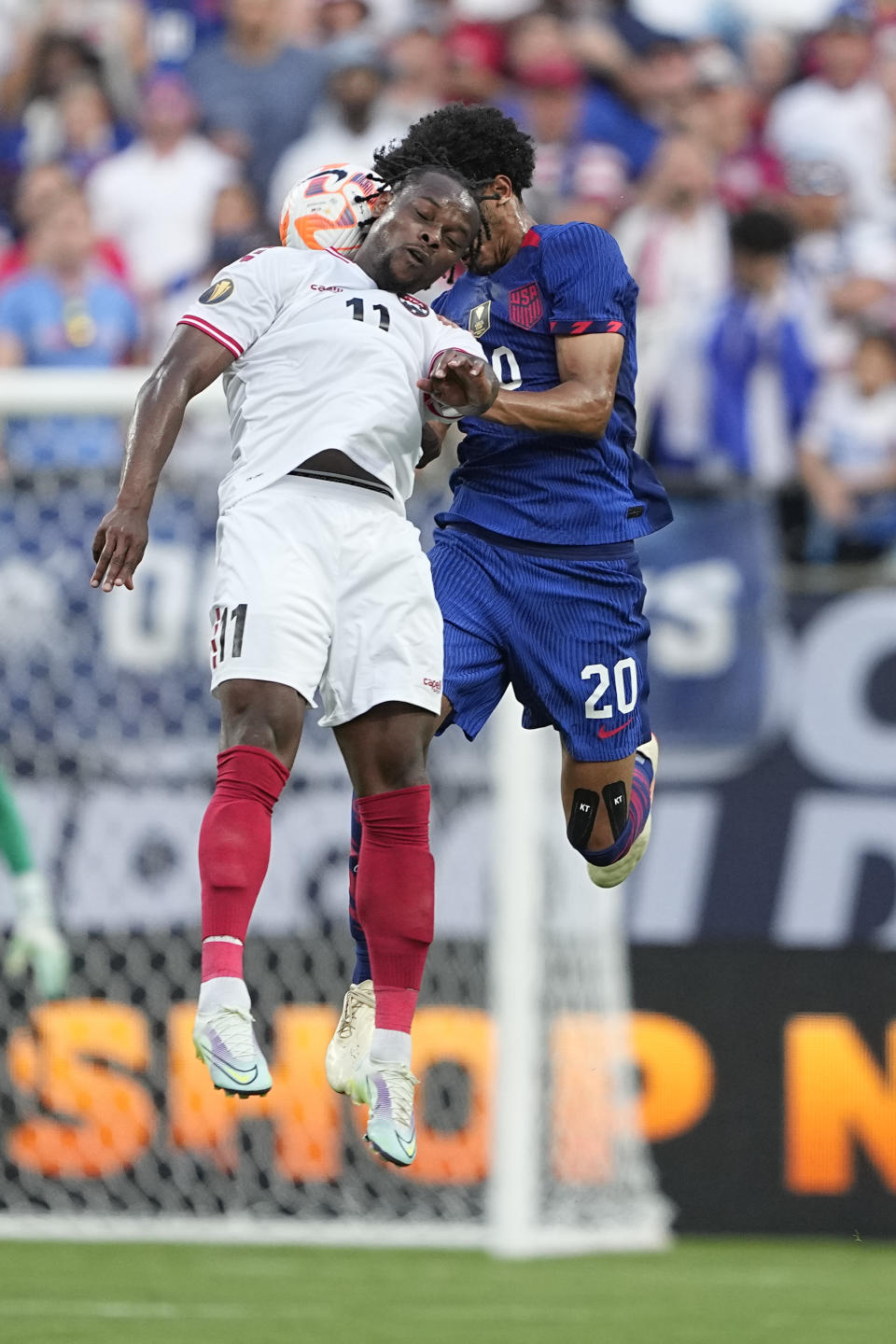 Trinidad and Tobago forward Levi García heads the ball away form United States defender Jalen Neal during the first half of a CONCACAF Gold Cup soccer match on Sunday, July 2, 2023, in Charlotte, N.C. (AP Photo/Chris Carlson)