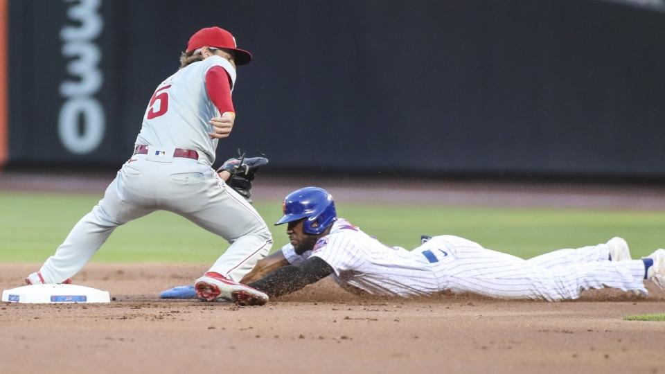 Philadelphia Phillies shortstop Bryson Stott (5) is unable to handle the throw allowing New York Mets right fielder Starling Marte (6) to steal second base in the first inning at Citi Field.