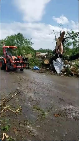 People work to clear debris in the aftermath of a tornado in Franklin, Texas, U.S., in this still image from social media video dated April 13, 2019. CHUCK BATTEN/via REUTERS