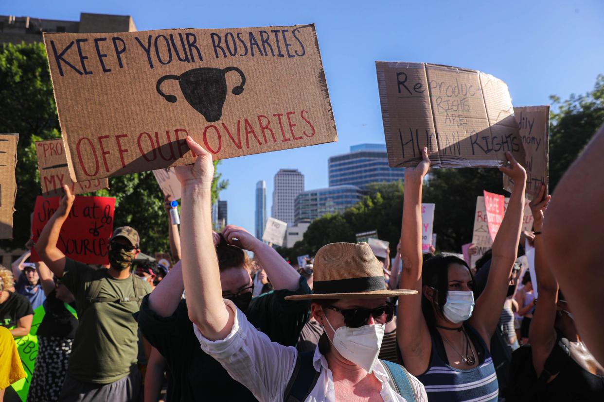 Beth Lemmons holds a sign and bows her head during a pro-choice protest in Austin, Texas that was a response to the United States Supreme Court overturning the landmark case Roe V. Wade on June 24, 2022.