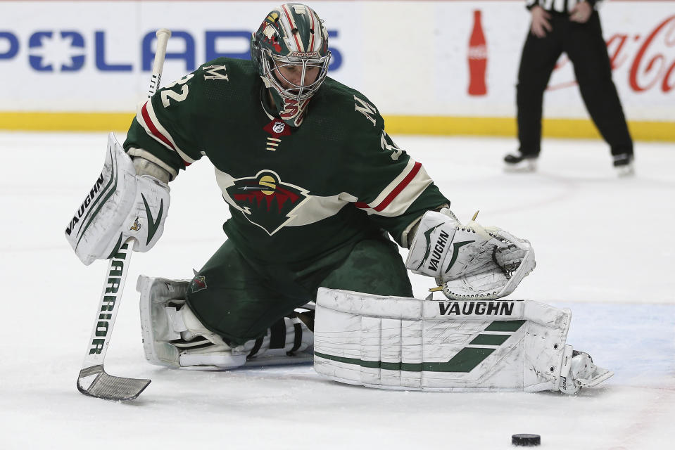 Minnesota Wild's goalie Alex Stalock deflects the puck in the second period of an NHL hockey game against the Dallas Stars, Saturday, Jan. 18, 2020, in St. Paul, Minn. (AP Photo/Stacy Bengs)