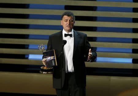 Steven Moffat accepts the award for Outstanding Writing for a Miniseries, Movie or a Dramatic Special for PBS' "Sherlock: His Last Vow" during the 66th Primetime Emmy Awards in Los Angeles, California August 25, 2014. REUTERS/Mario Anzuoni