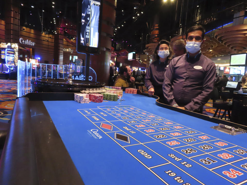 Roulette dealers at the Ocean Casino Resort in Atlantic City, N.J., wait for customers on Dec. 2, 2022. New development projects at casinos and a former airport site, along with a long-awaited year-round water park are among things expected to happen in Atlantic City in 2023. (AP Photo/Wayne Parry)